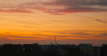 Breathtaking urban landscape at sunset with rooftops and city silhouette