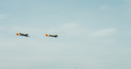 Two Yak-52 aircraft perform a demonstration flight at BIAS 2024. Aircraft that synchronize perfectly and fly at an air show. YAK-52 Air Force Romania