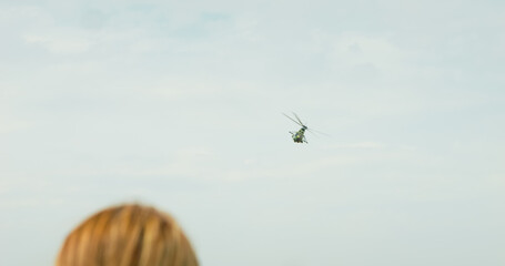 People watching a helicopter demonstration IAR 330 Puma SOCAT at Bucharest International Air Show. IAR 330 Puma SOCAT a military helicopter at BIAS 2024.