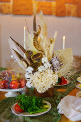 Floral arrangement with fruits and candles