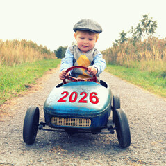 little boy driving a car in the new year 2026