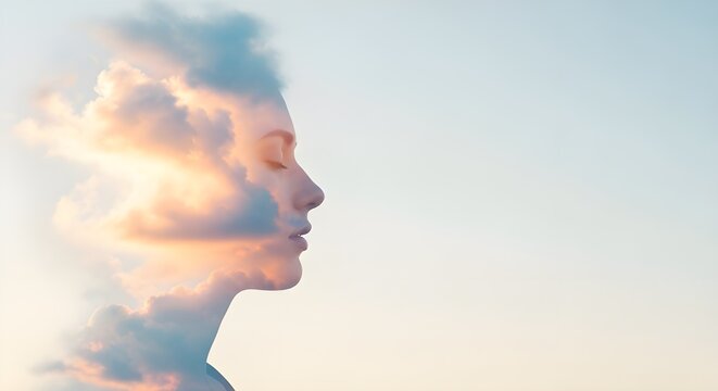 Double exposure of a womans profile with clouds and sunset sky