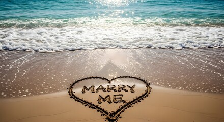 Romantic beach proposal marry me written in sand with ocean waves