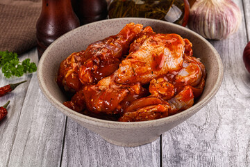 Raw marinated buffalo chicken wings