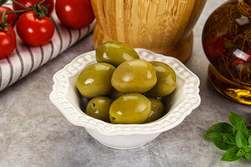 Big green marinated olives in the bowl