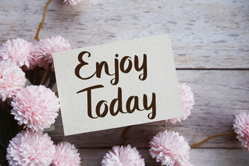 Enjoy Today Motivational and Inspirational quotes with flowers bouquet decoration on wooen...