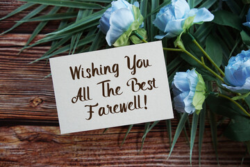 Wishing You All The Best Farewell! Motivational and Inspirational quotes with flowers bouquet decoration on wooen background