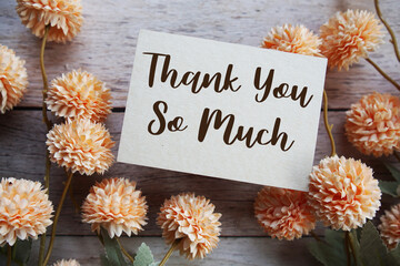 Thank You text with flowers bouquet decoration on wooen background