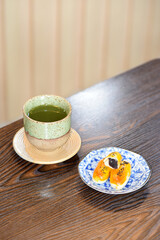 Hot Matcha green tea cup with Chinese pastry