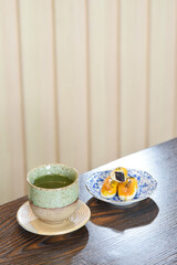 Hot Matcha green tea cup with Chinese pastry