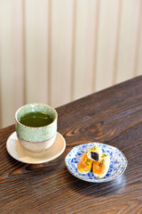 Hot Matcha green tea cup with Chinese pastry