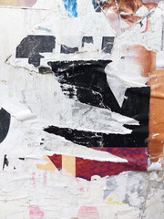 Fototapeta premium Old torn and ripped street poster background, weathered and messy paper texture
