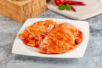 Raw chicken marinated thighs with skin