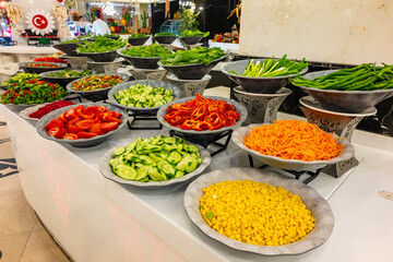 Mediterranean cuisine, olive oil, healthy and delicious  salad varieties with green vegetables.Vegetarian and vegan healty food, open buffet in a luxury hotel. Meze varieties, salad bar.