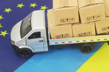 Lorry truck with many boxes on flags of EU and Ukraine. Export from Ukraine to EU concept.