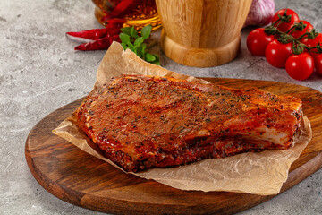 Raw marinated pork loin steak