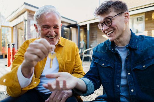 Father and son celebrating new home ownership outdoors