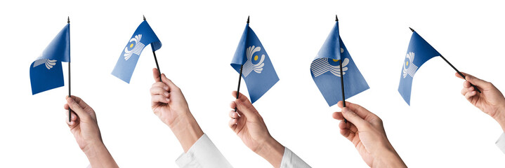 The CIS flag in hand in different angles on a white background
