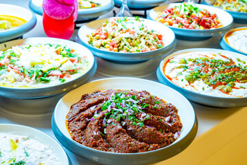 Mediterranean cuisine, olive oil, healthy and delicious  salad varieties with green vegetables.Vegetarian and vegan healty food, open buffet in a luxury hotel. Meze varieties, salad bar.