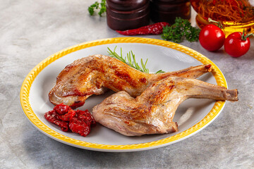 Roasted rabbit leg served rosemary