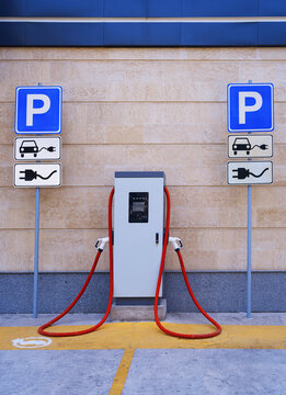 Electric car charging station with parking signs outdoors