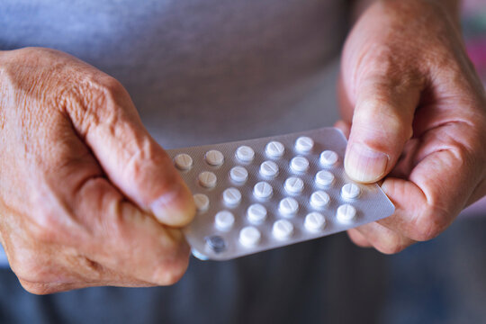 Hand holding a blister pack of pills suggesting healthcare and medication