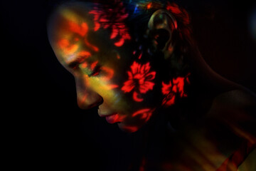 Surreal portrait with floral pattern illumination and dreamlike mood