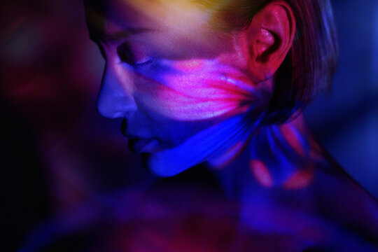 Dreamlike portrait with floral virtual reality illumination and mystery