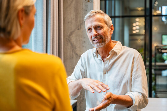 Mature colleagues having a business discussion in office setting