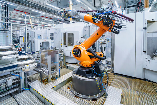 Industrial robot arm in automated production hall with machinery