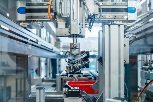 Industrial robot working with machinery in automated factory