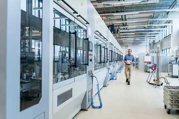 Engineer in modern automated industrial facility with advanced machinery