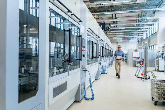 Engineer in modern automated industrial facility with advanced machinery