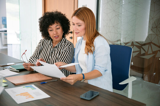 Teamwork and planning with documents and charts in office workspace