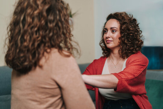 Therapy session with supportive eye contact and conversation on sofa