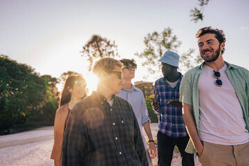 A diverse group of friends enjoy outdoor togetherness, celebrating unity, happiness, freedom, and...