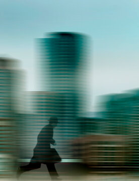 Man running in city with motion blur conveying hurry and speed