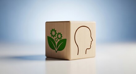Wooden cube with green leaf and gear symbol on one side and human head outline on the other, representing ecofriendly technology and innovation