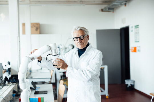Engineer working with a robot in a laboratory setting