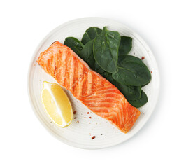 Piece of tasty grilled salmon, lemon slice and spinach isolated on white, top view
