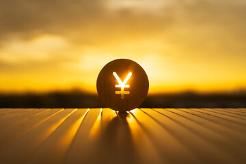 Wooden yen currency symbol glowing with sunset light, representing Asian economy, Japanese financial growth, currency exchange, and global investment opportunities in warm conceptual background.