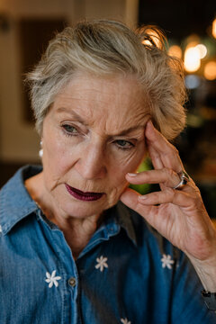 Small business owner with silver hair thinking and experiencing burn-out