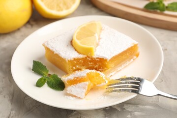 Tasty lemon bar with mint and fresh fruits on grey marble table, closeup