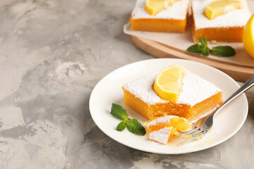 Tasty lemon bars with mint on grey marble table, closeup. Space for text
