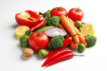 Different fresh raw vegetables on white wooden table, closeup