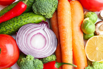 Different fresh raw vegetables and lemon on white table, flat lay