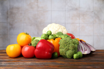Different fresh raw vegetables on wooden table, closeup