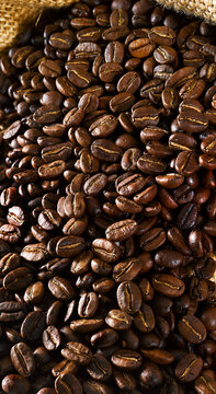 Roasted coffee bean close up in sack as food background