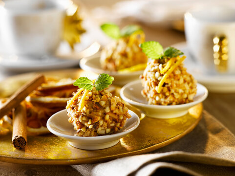 Festive Italian nut confection dessert on golden plate with garnish
