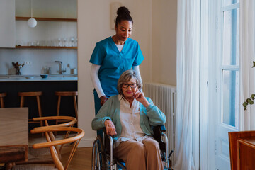 Nurse offering compassionate care to woman in wheelchair at home